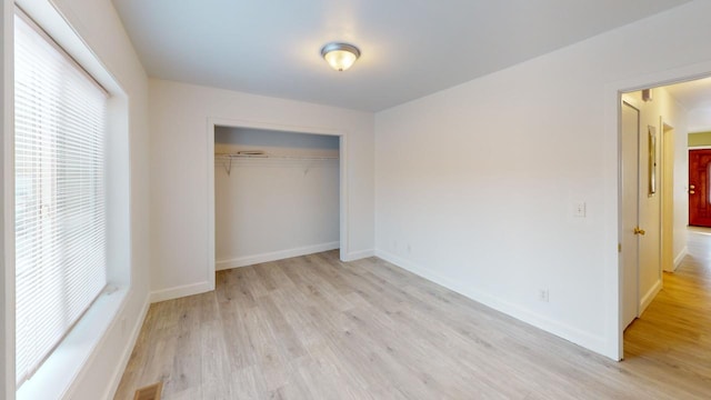 unfurnished bedroom featuring a closet and light hardwood / wood-style flooring