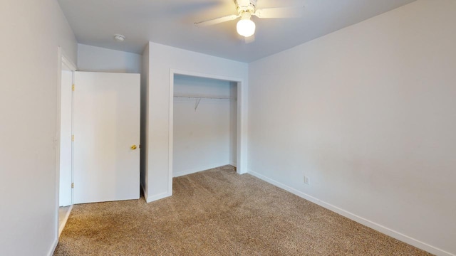 unfurnished bedroom with light carpet, ceiling fan, and a closet