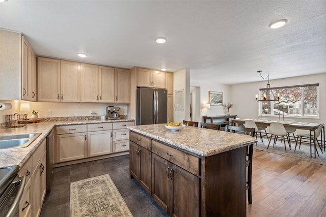 kitchen featuring electric range oven, pendant lighting, dark wood-type flooring, an inviting chandelier, and stainless steel fridge