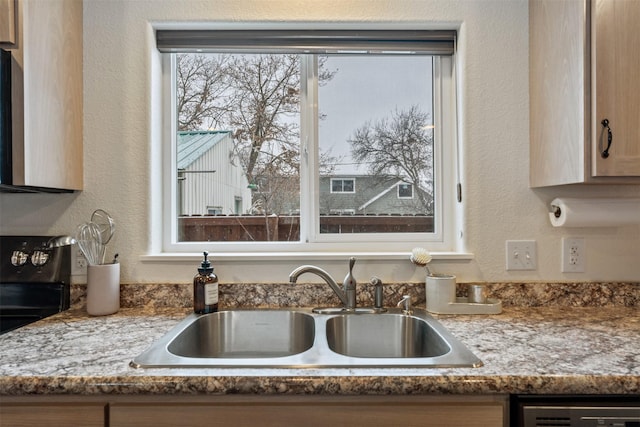 interior details with dishwashing machine, sink, light brown cabinets, and stone countertops