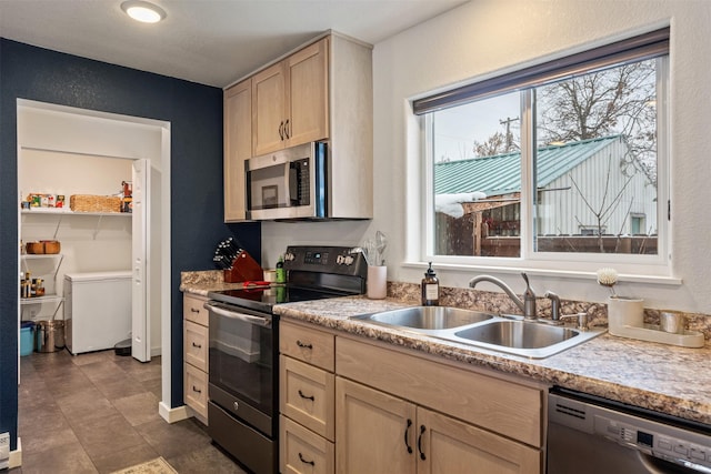 kitchen featuring black dishwasher, sink, light brown cabinets, and electric range oven