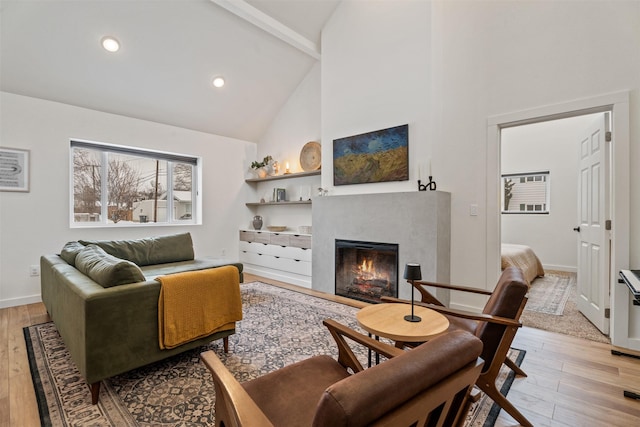 living room featuring high vaulted ceiling, beam ceiling, and light wood-type flooring