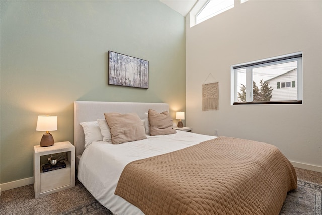 bedroom featuring carpet and high vaulted ceiling