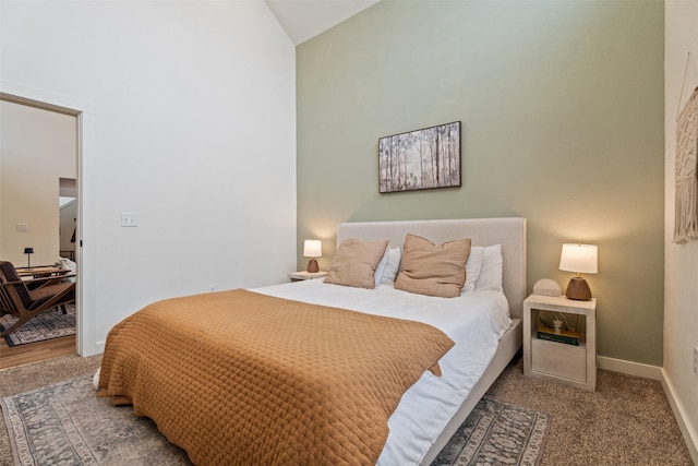 carpeted bedroom with lofted ceiling