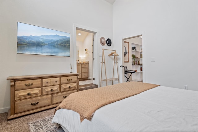 carpeted bedroom featuring ensuite bathroom