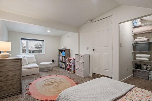 bedroom with vaulted ceiling and dark carpet