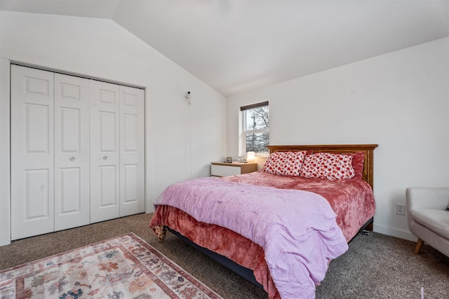 bedroom with vaulted ceiling, a closet, and carpet flooring