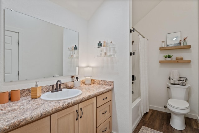 full bathroom featuring toilet, vanity, vaulted ceiling, shower / tub combo, and hardwood / wood-style flooring