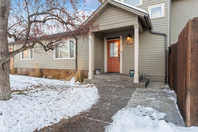 view of snow covered property entrance