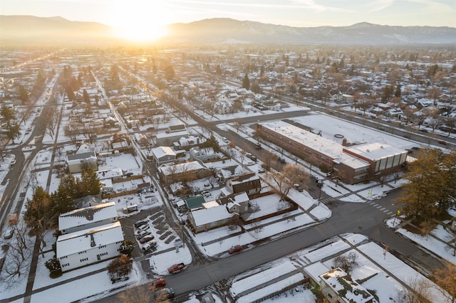 snowy aerial view with a mountain view