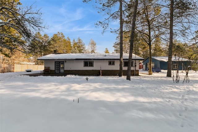 view of snow covered rear of property