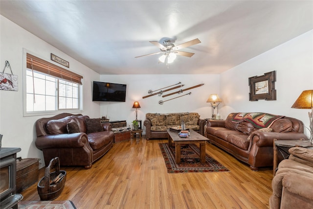 living area with ceiling fan and wood finished floors
