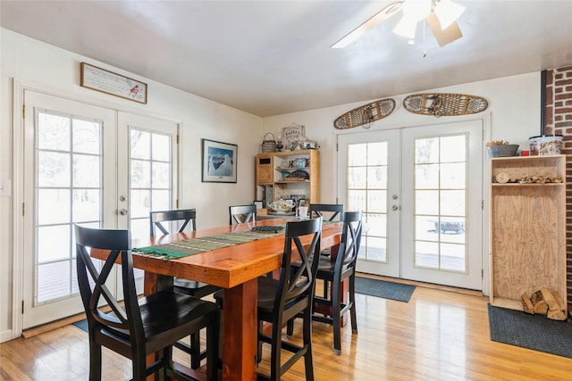 dining space featuring ceiling fan, french doors, and light hardwood / wood-style floors