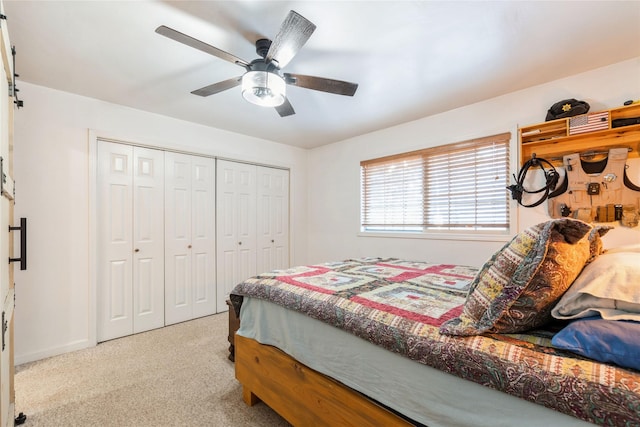 carpeted bedroom with ceiling fan and a closet