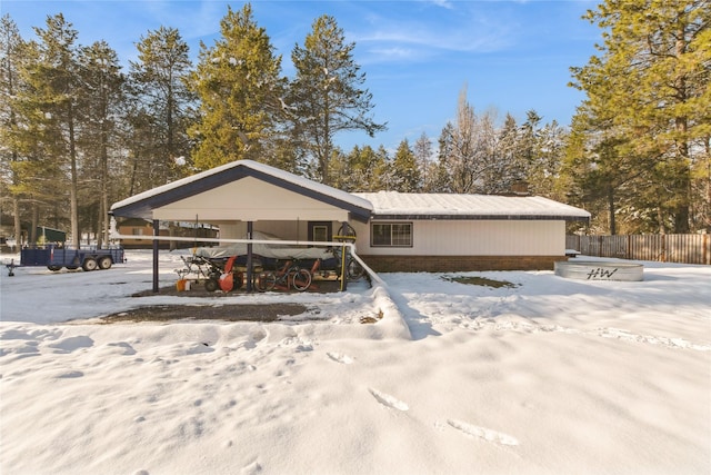 view of front of house featuring fence and brick siding