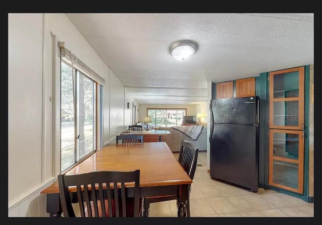 dining area featuring a textured ceiling