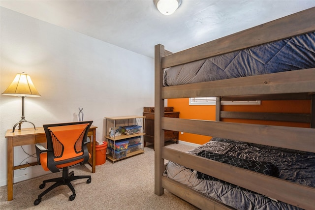 bedroom with carpet floors and an office area