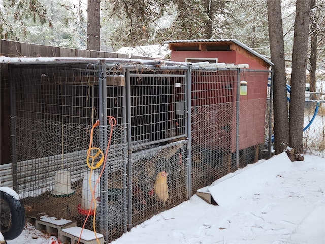 snow covered structure with exterior structure and an outdoor structure