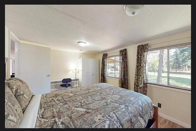 bedroom featuring a textured ceiling and hardwood / wood-style floors