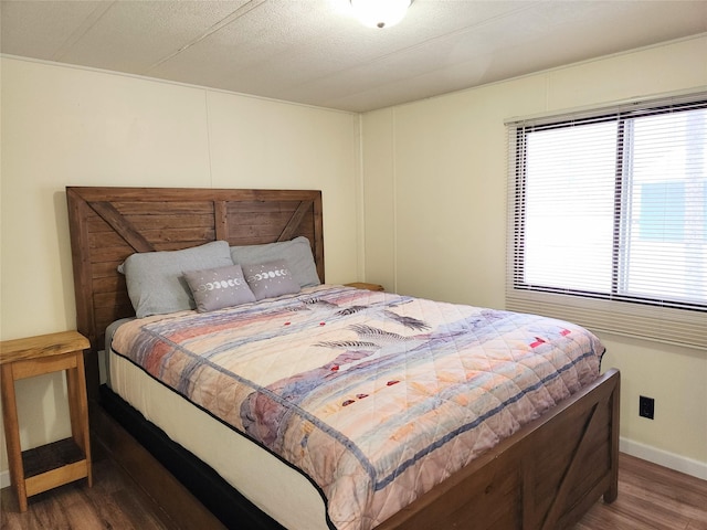 bedroom with dark hardwood / wood-style floors