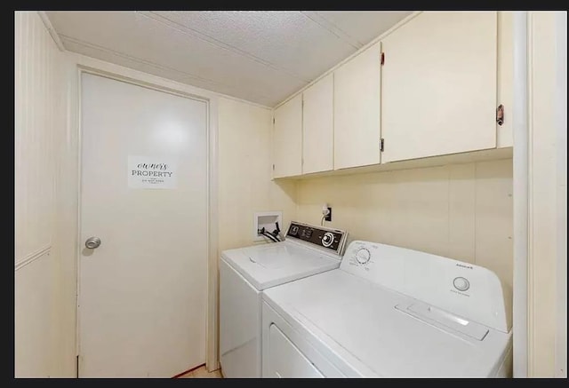 washroom with independent washer and dryer and cabinets