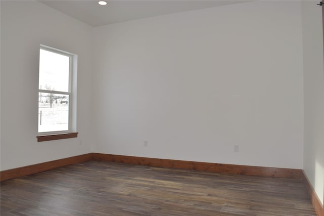 unfurnished room featuring plenty of natural light and dark hardwood / wood-style flooring