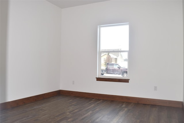 unfurnished room with dark hardwood / wood-style flooring