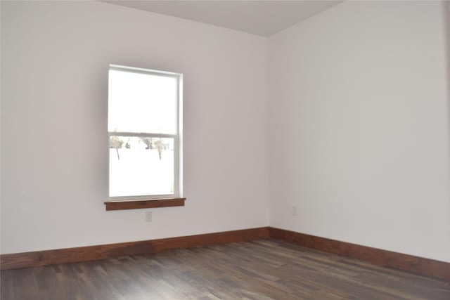 spare room with dark hardwood / wood-style flooring