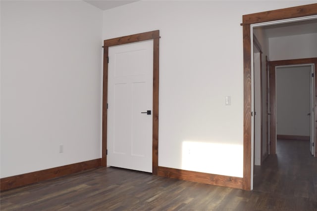 spare room featuring dark hardwood / wood-style flooring