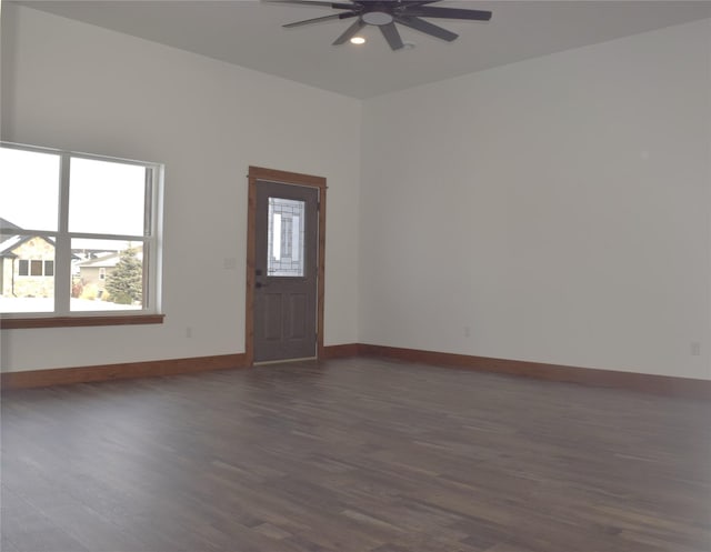 empty room featuring ceiling fan and dark hardwood / wood-style flooring