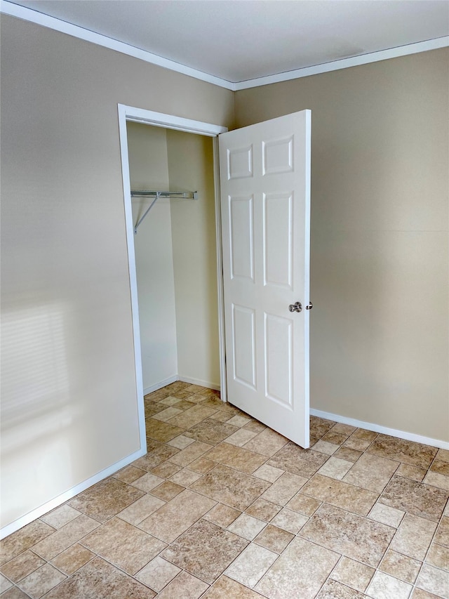 unfurnished bedroom featuring a closet and ornamental molding