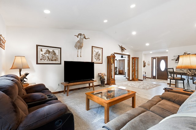 living room featuring lofted ceiling and light wood-type flooring