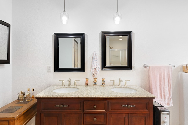 bathroom featuring an enclosed shower, vanity, and radiator heating unit