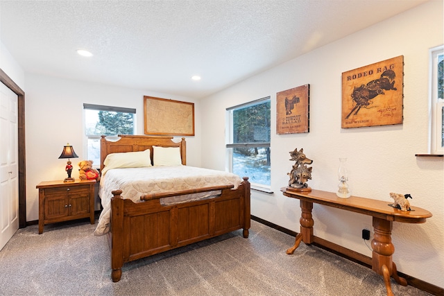 bedroom with a textured ceiling and carpet