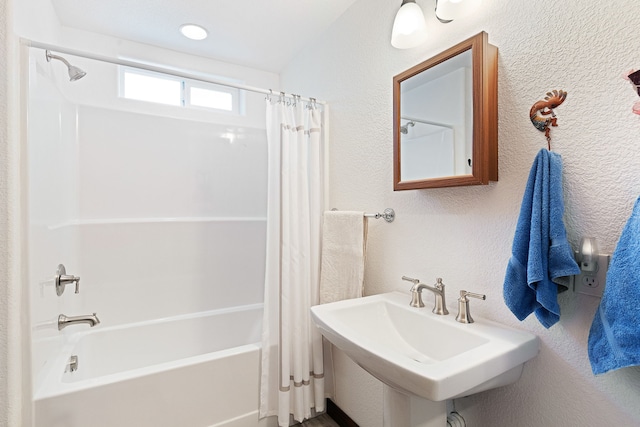 bathroom with sink and shower / bath combo with shower curtain