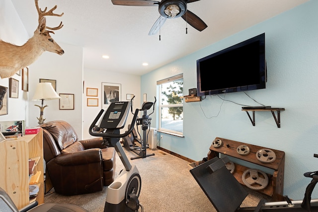 workout area with ceiling fan and carpet