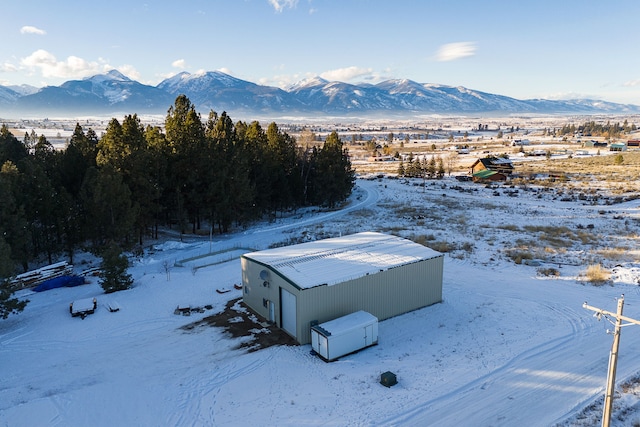 snowy aerial view featuring a mountain view