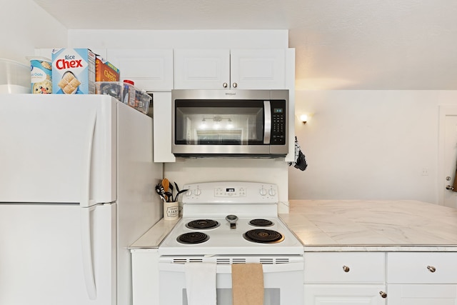 kitchen featuring white cabinetry and white appliances