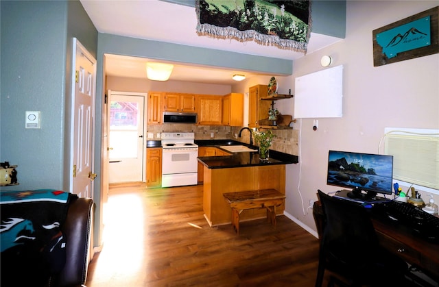 kitchen with wood-type flooring, decorative backsplash, white electric range oven, sink, and kitchen peninsula