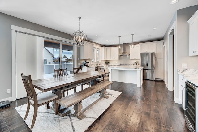 dining space featuring wine cooler, dark hardwood / wood-style floors, and a notable chandelier