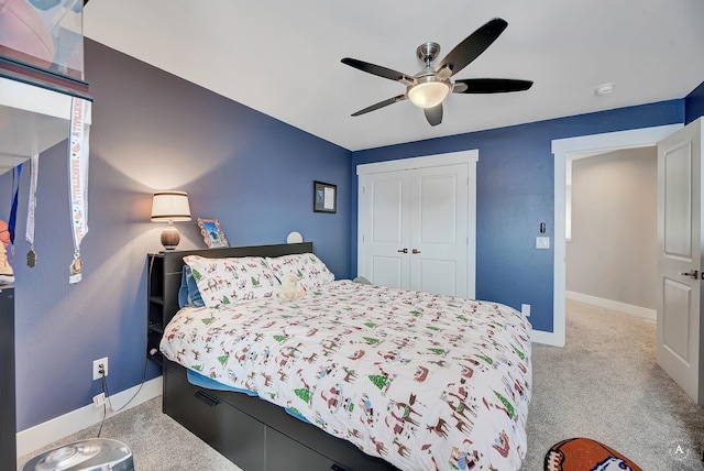 carpeted bedroom featuring ceiling fan and a closet