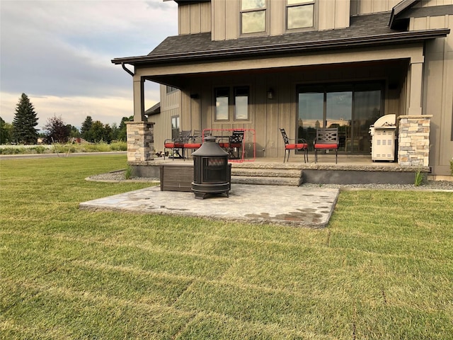 back of house featuring a patio area and a lawn