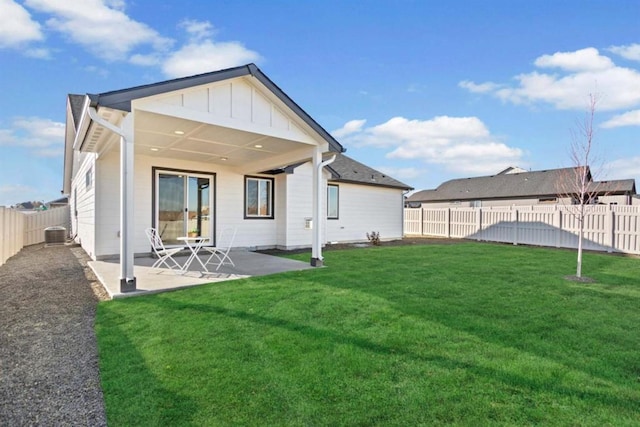 rear view of house with a patio area, a lawn, and central air condition unit