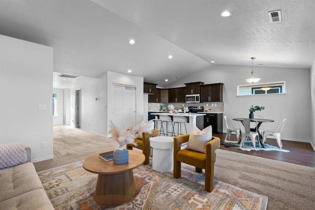 living room featuring vaulted ceiling and carpet flooring