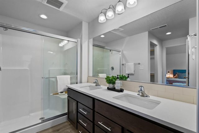 bathroom featuring vanity, hardwood / wood-style flooring, and an enclosed shower