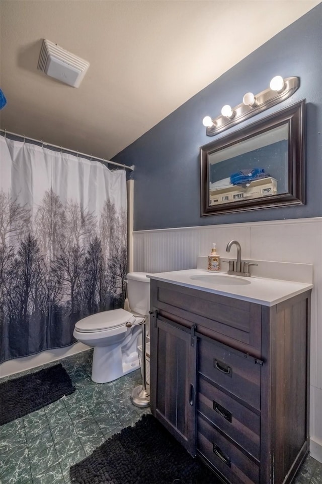 3761 Aster St, East Helena, MT 59635 - full bath featuring visible vents, a shower with curtain, toilet, vanity, and wainscoting