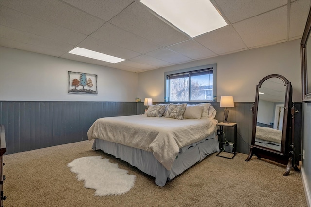 3761 Aster St, East Helena, MT 59635 - bedroom featuring a paneled ceiling, wood walls, light colored carpet, and wainscoting