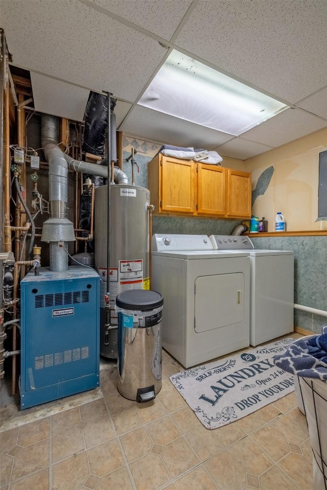 3761 Aster St, East Helena, MT 59635 - washroom featuring water heater, light tile patterned flooring, washer and clothes dryer, cabinet space, and a heating unit