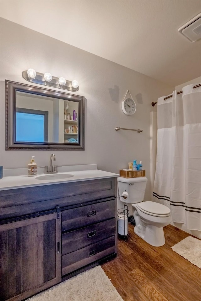 3761 Aster St, East Helena, MT 59635 - bathroom featuring vanity, a shower with curtain, visible vents, toilet, and wood finished floors