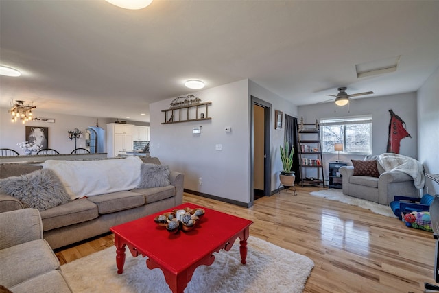 3761 Aster St, East Helena, MT 59635 - living area with attic access, light wood-type flooring, and baseboards